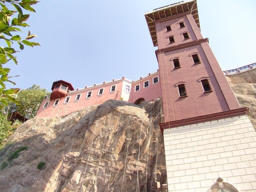 Pink building on a cliff