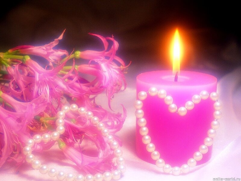 Pink candle with flowers and pearls
