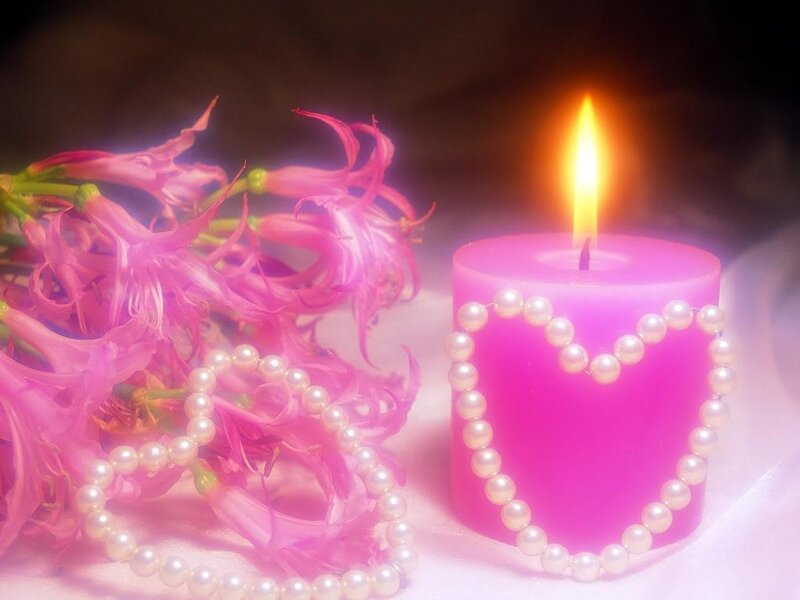 Pink candle with flowers and pearls