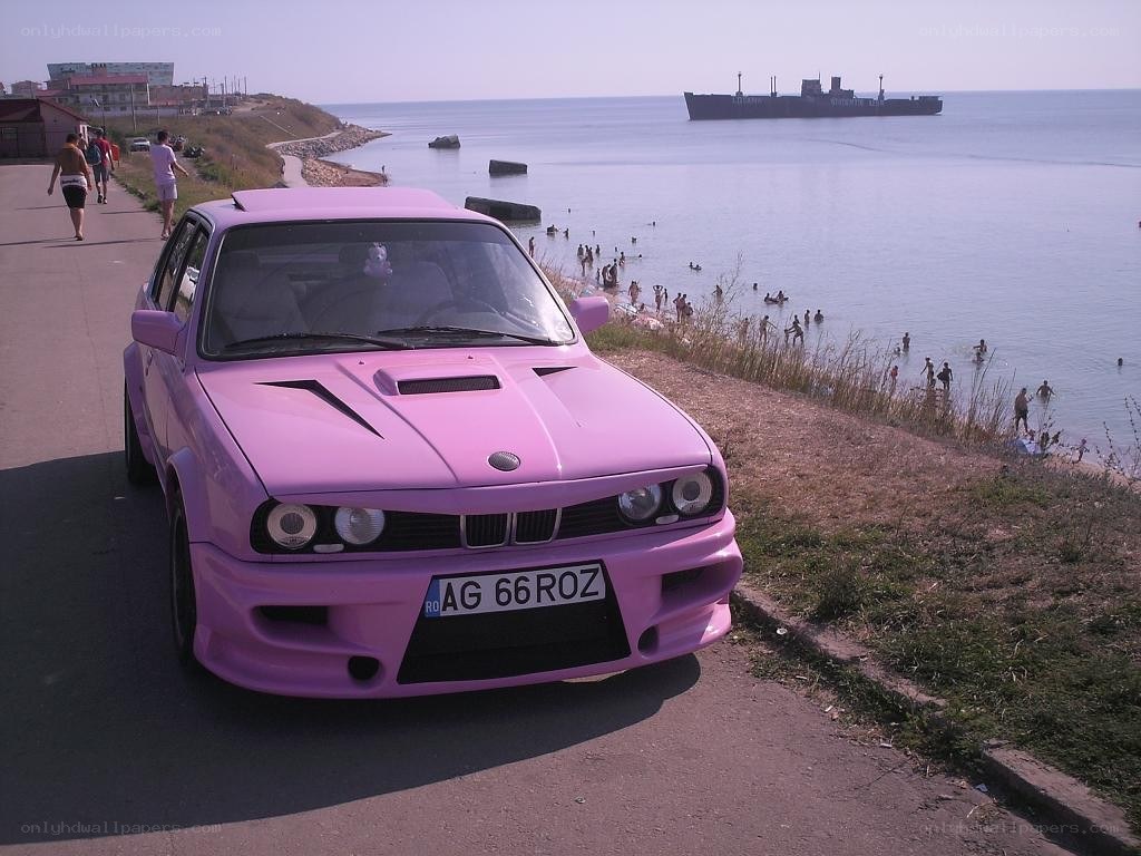 Pink car by the sea