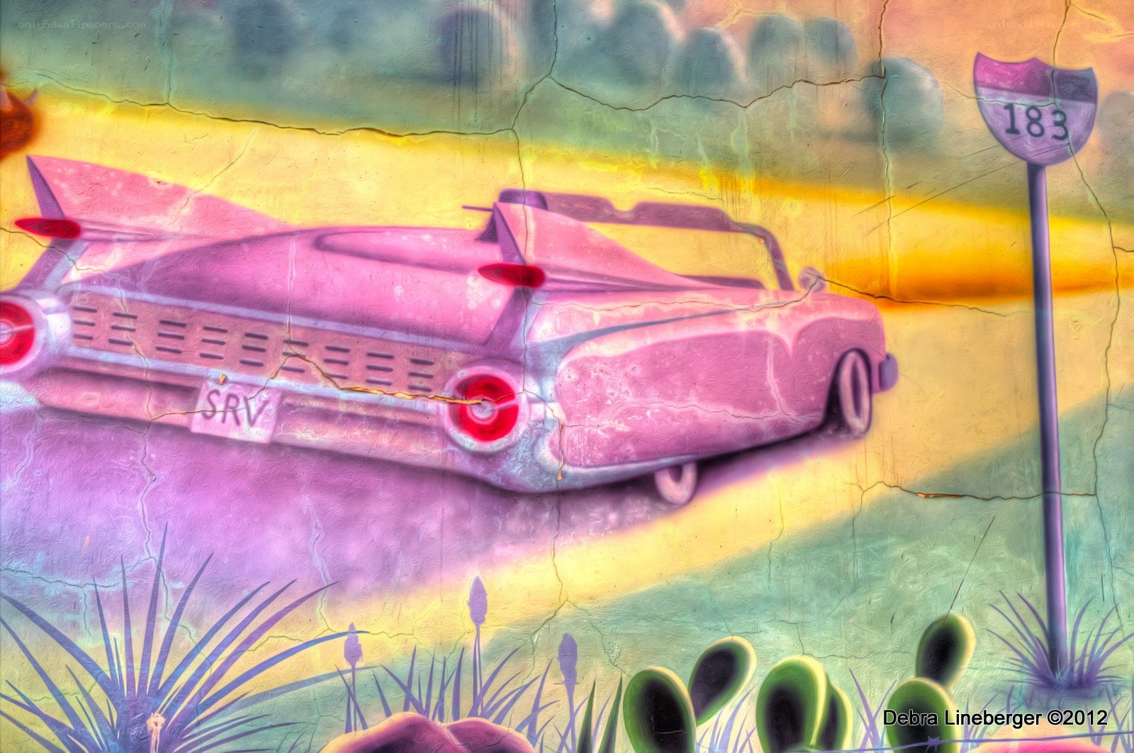 Pink car mural on cracked wall