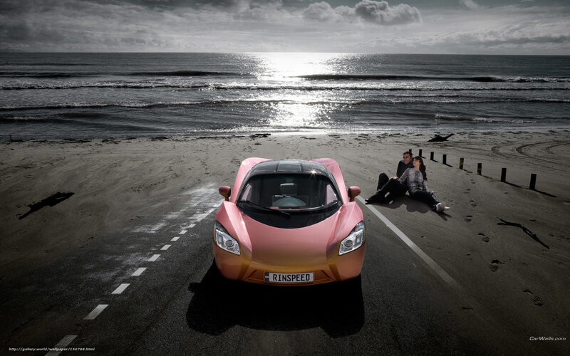 Pink car on beach at sunset