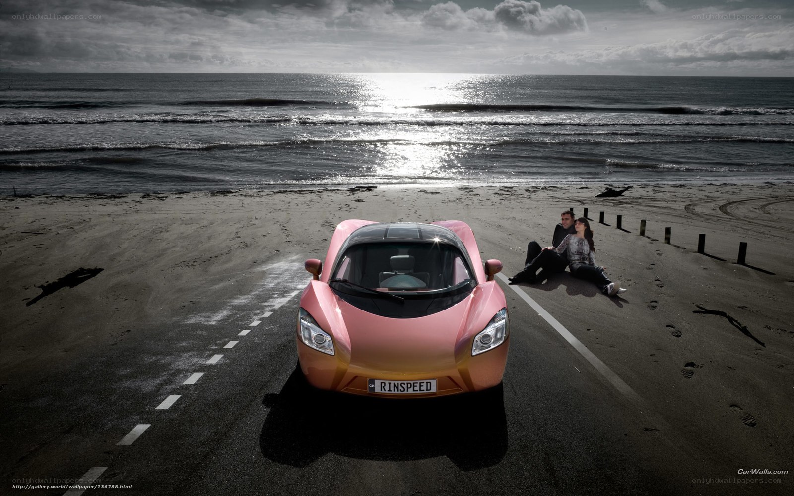 Pink car on beach at sunset