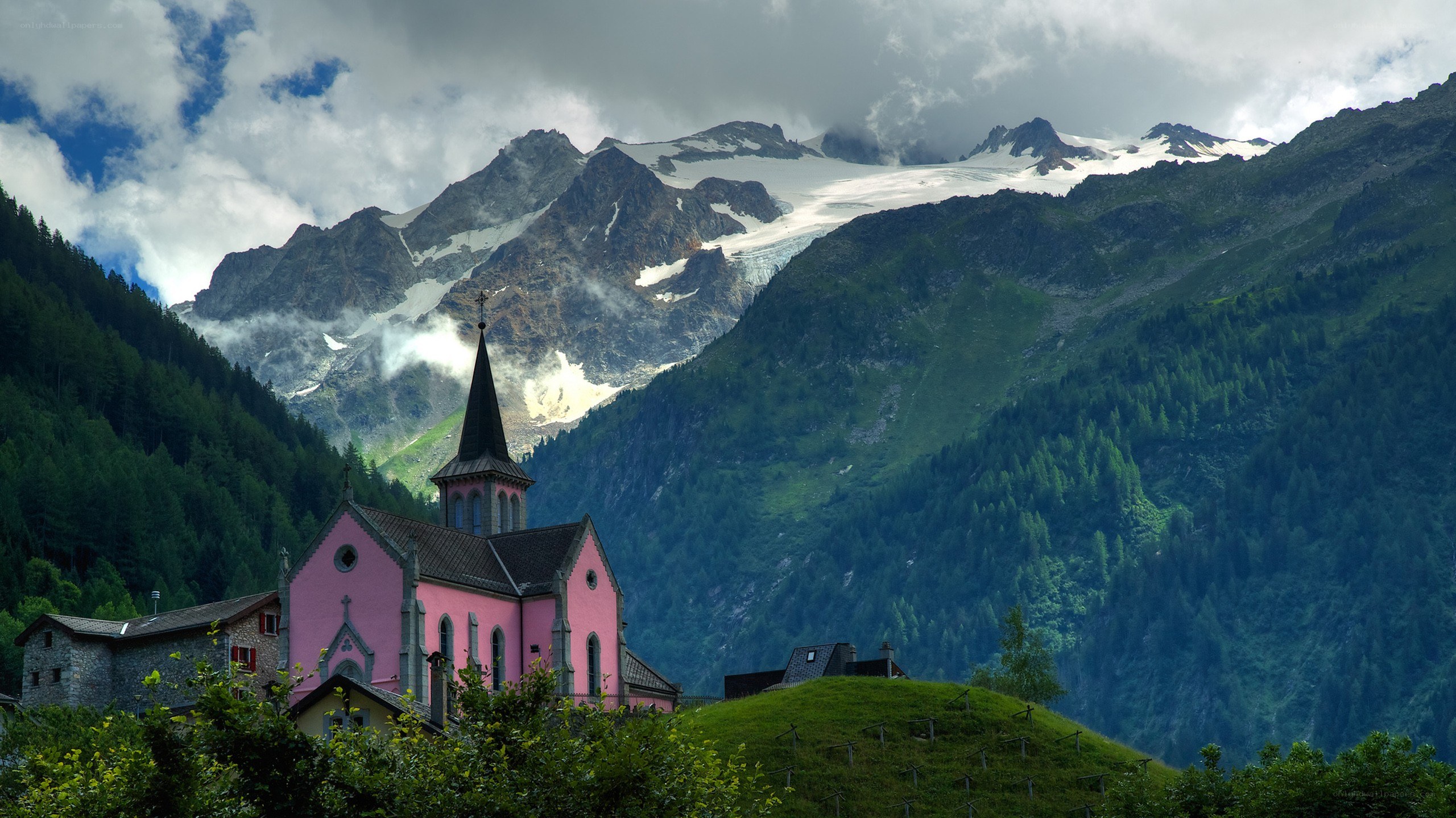 Pink church in mountain valley