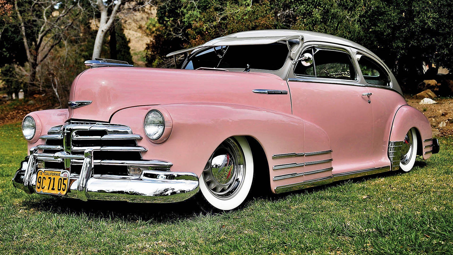 pink classic car on grass