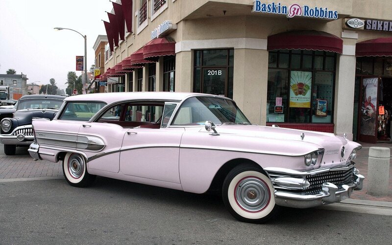 Pink classic car on street