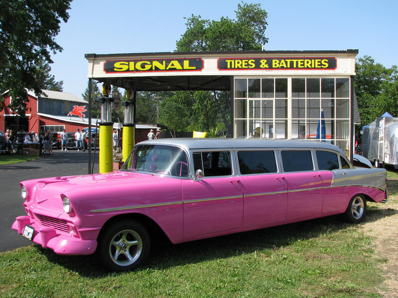 Pink classic limousine at gas station