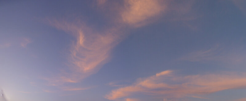 Pink clouds in blue sky