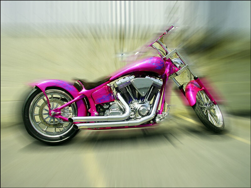 pink custom motorcycle in motion