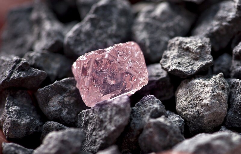 Pink diamond among rough stones