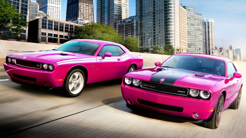 Pink Dodge Challengers in city