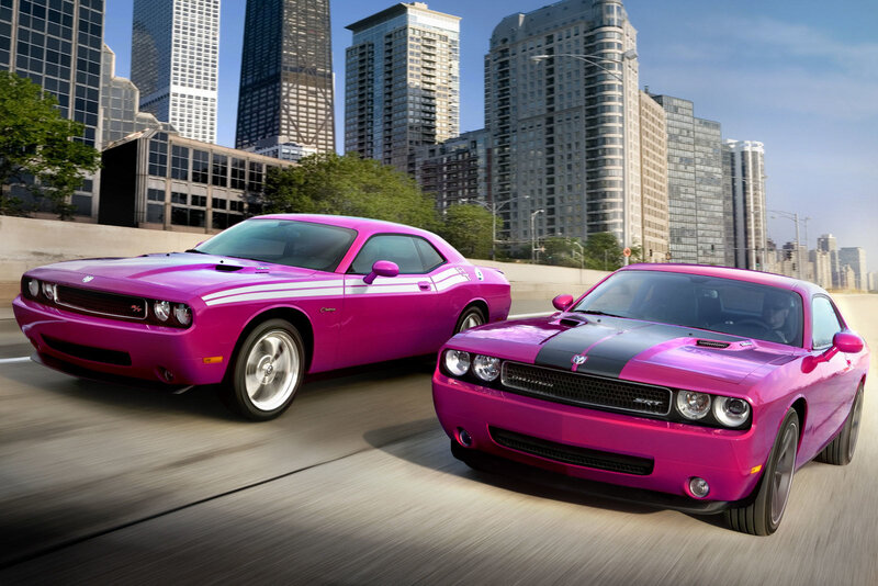 Pink Dodge Challengers in city