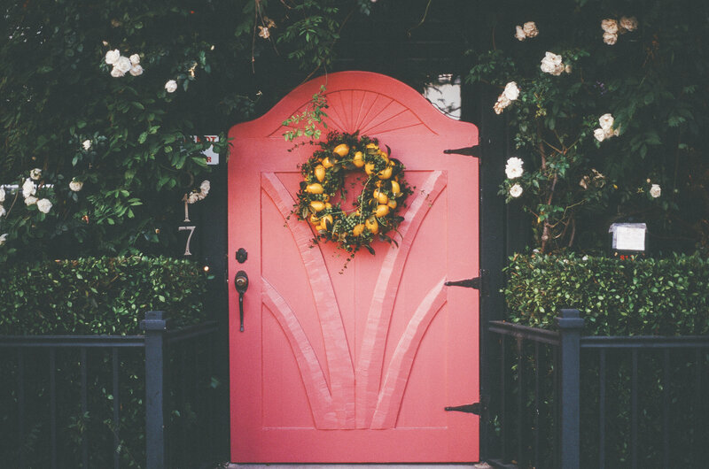 pink door with lemon wreath
