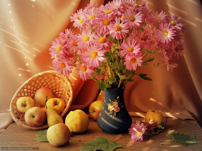 Pink flowers and fruit on table
