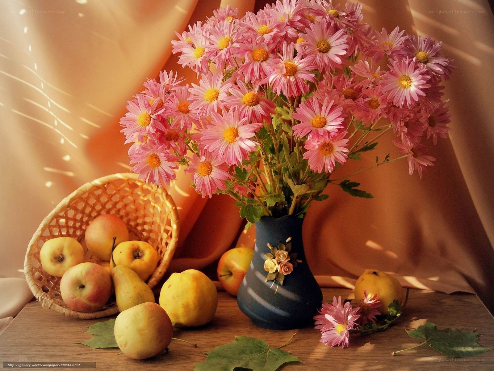 Pink flowers and fruit on table