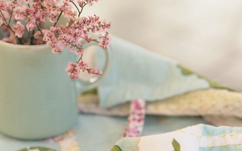 Pink flowers in a green mug