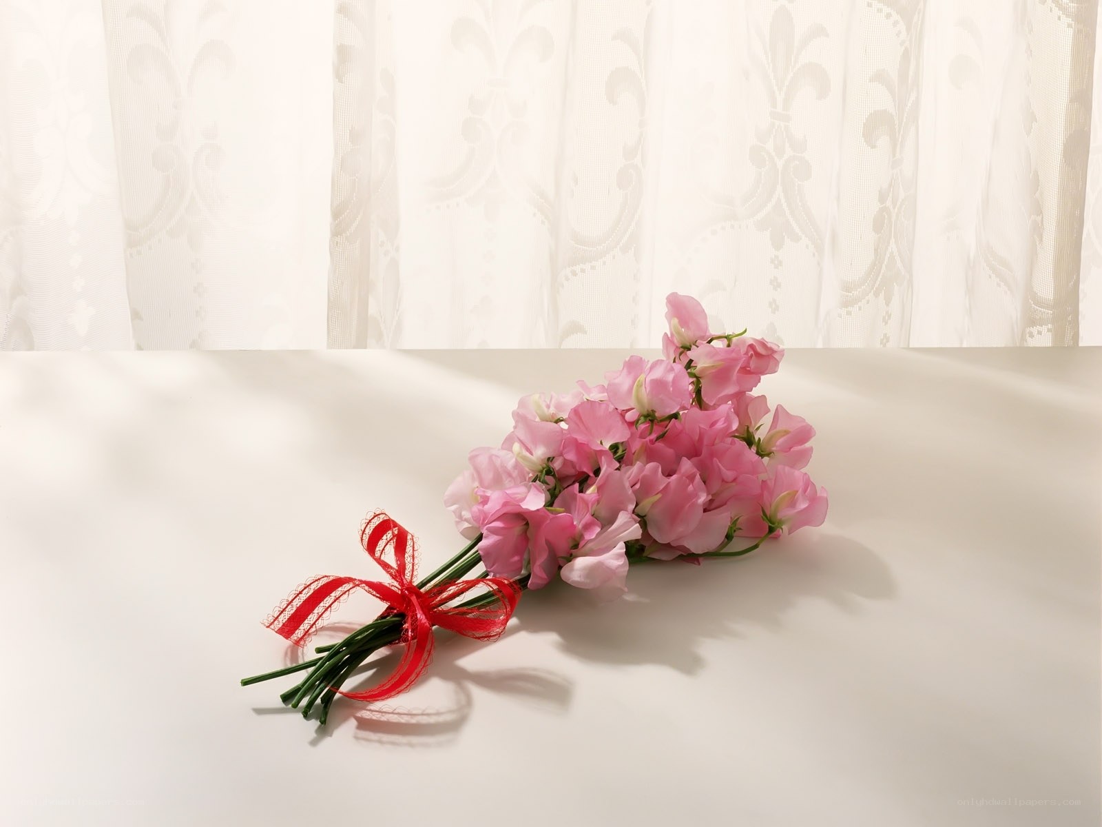 Pink flowers with red ribbon