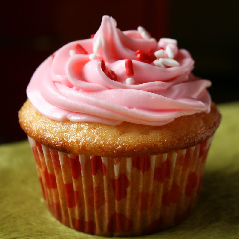 Pink-frosted cupcake with sprinkles