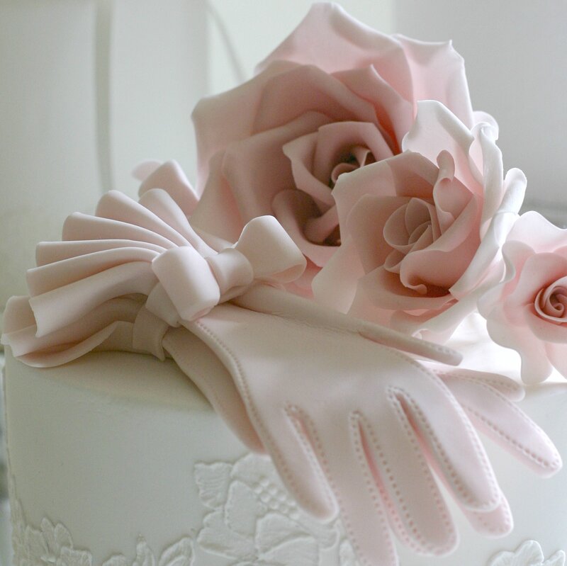 Pink-gloved Hand on Cake