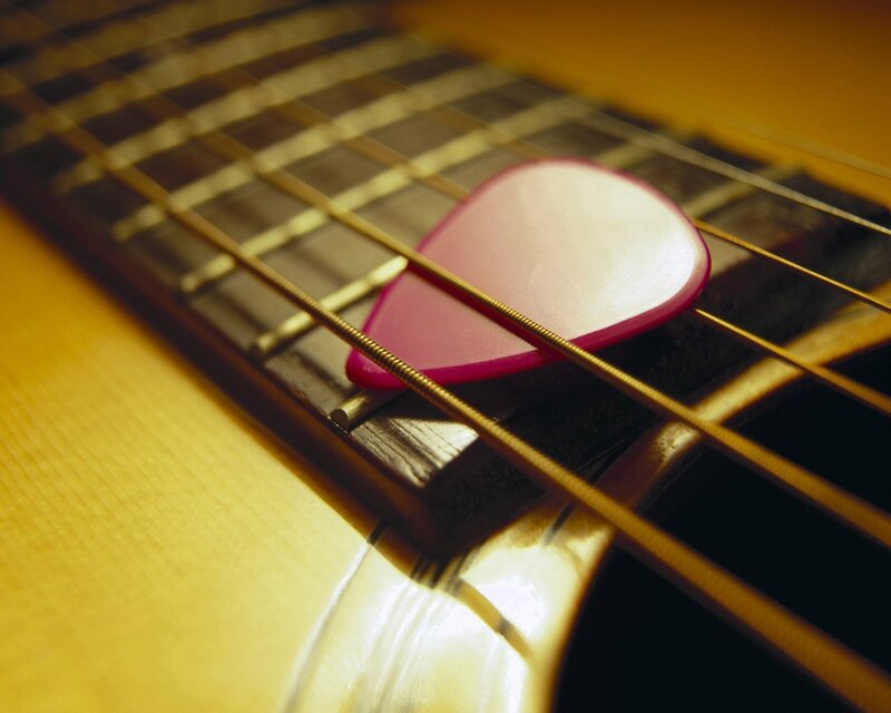 Pink Guitar Pick on Strings