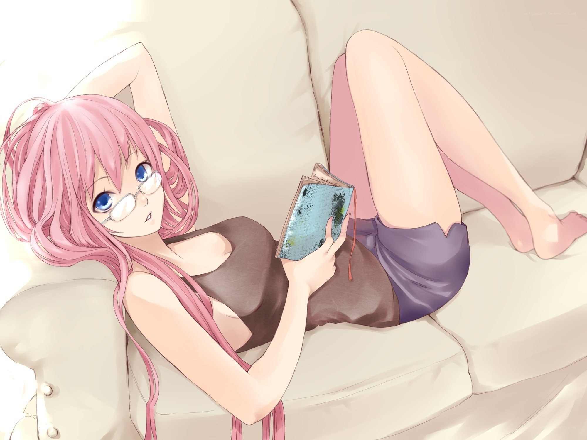 Pink-haired girl reading on couch