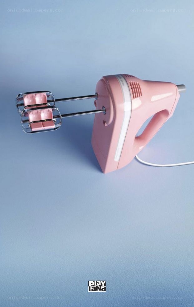pink hand mixer on blue