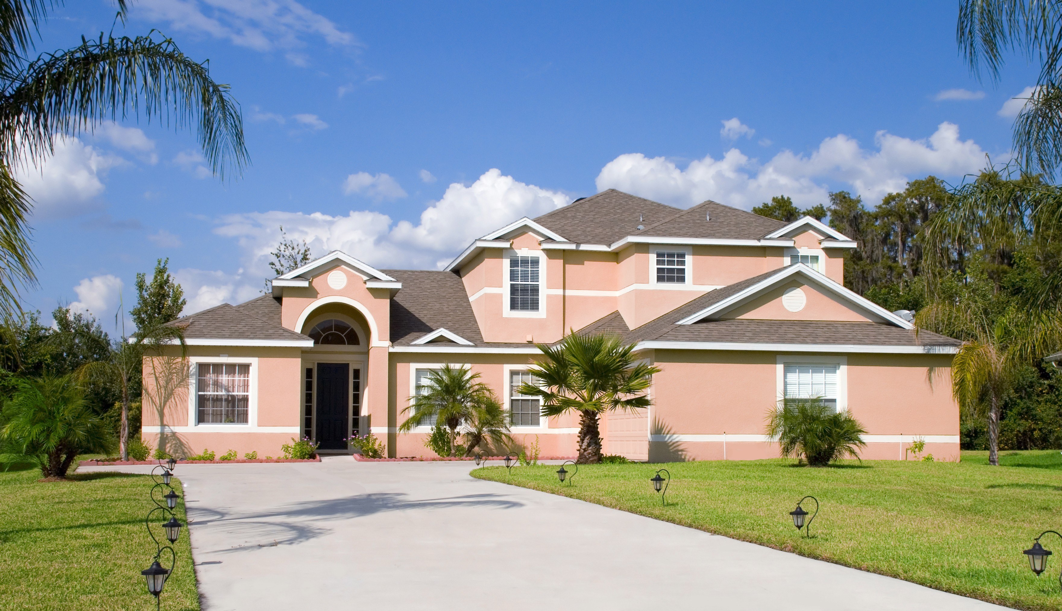 pink house with palm trees