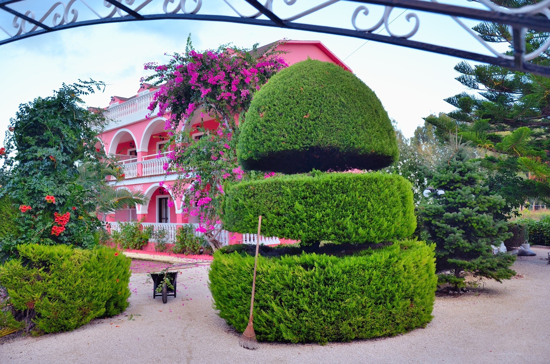 Pink house with topiary garden