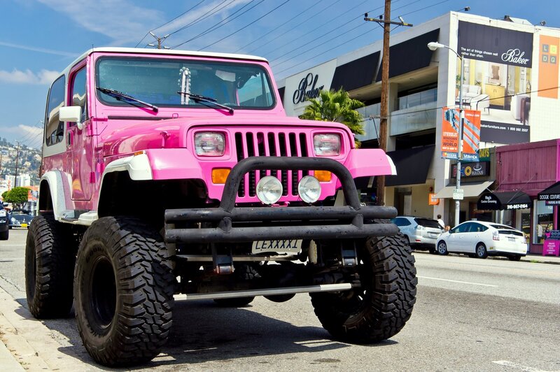pink jeep on city street