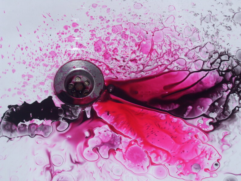 pink liquid draining in sink