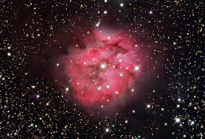 Pink nebula in star field