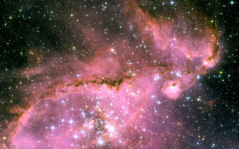Pink nebula in star field