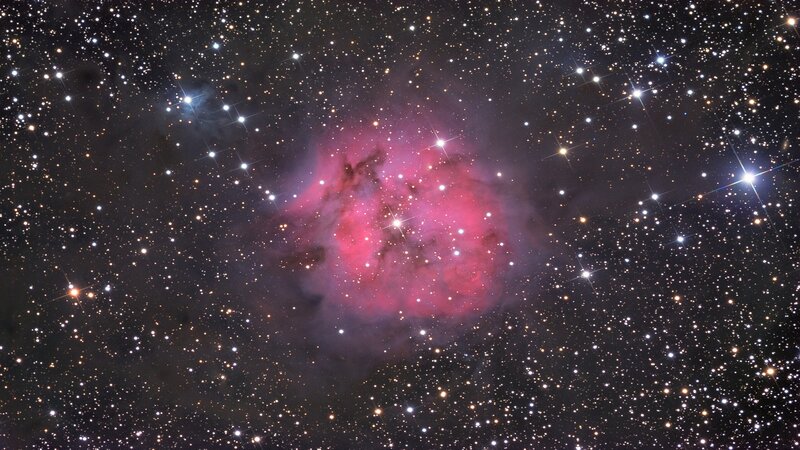 Pink nebula in star field