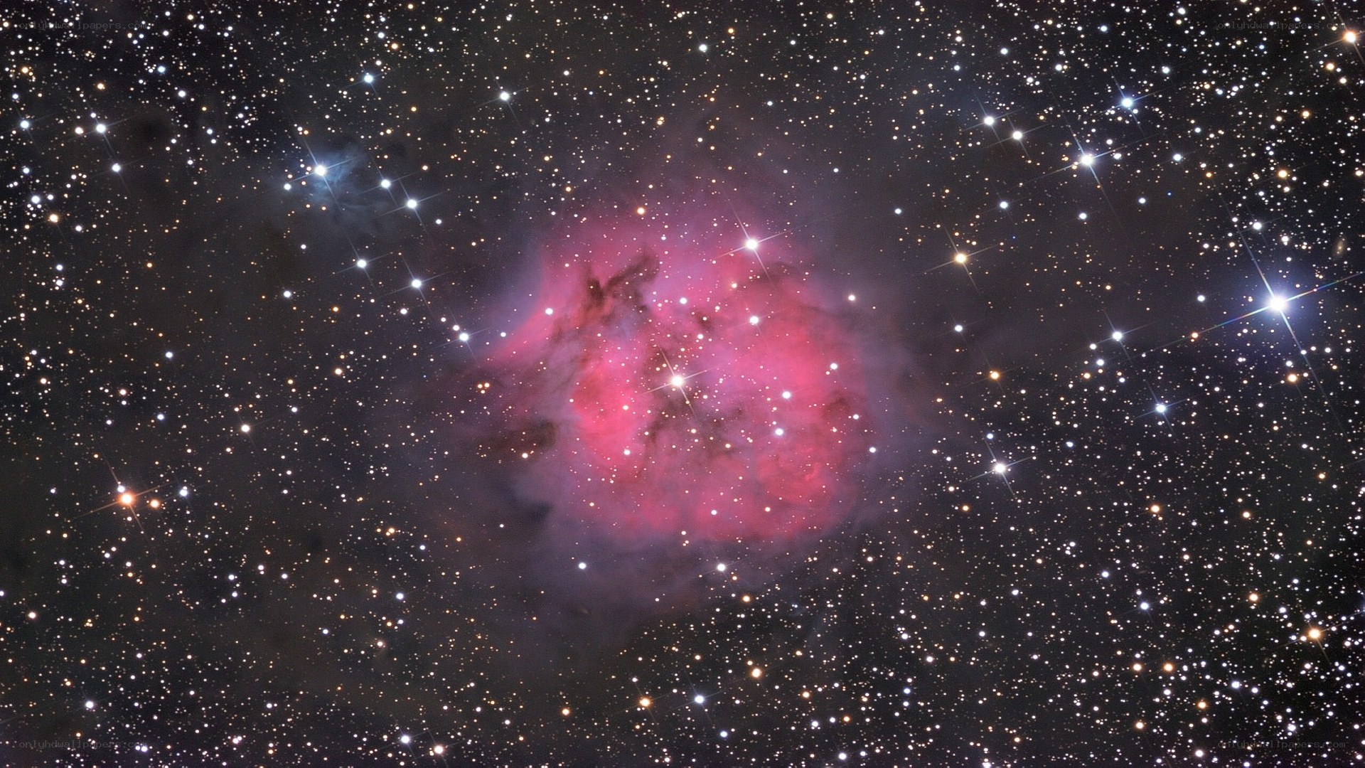 Pink nebula in star field