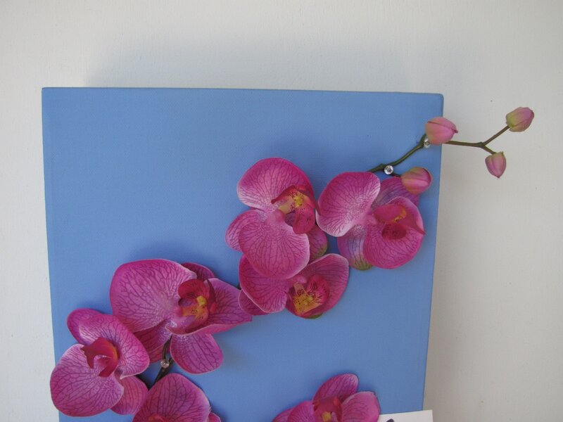 Pink orchids on blue canvas