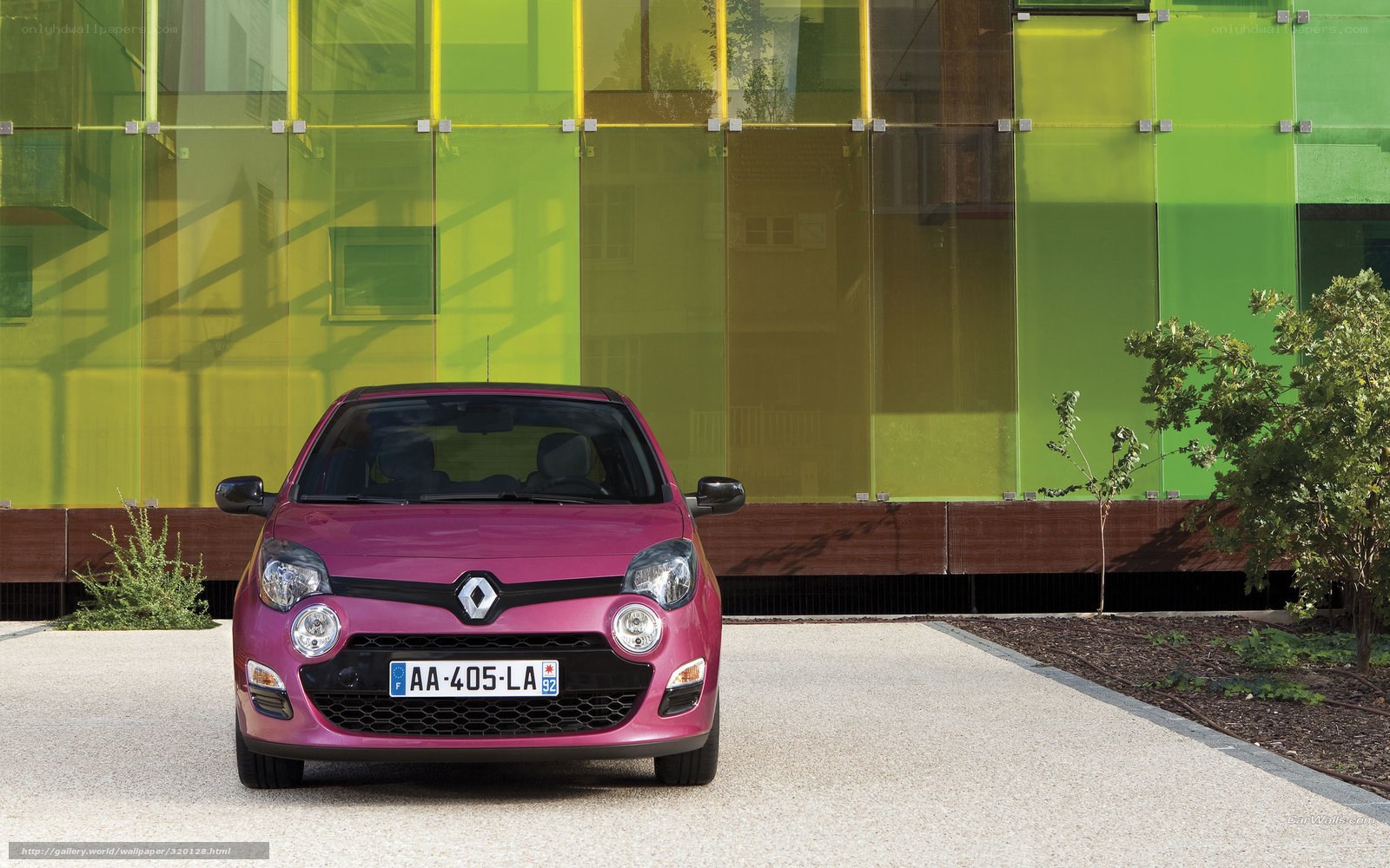 pink renault car in front of green building