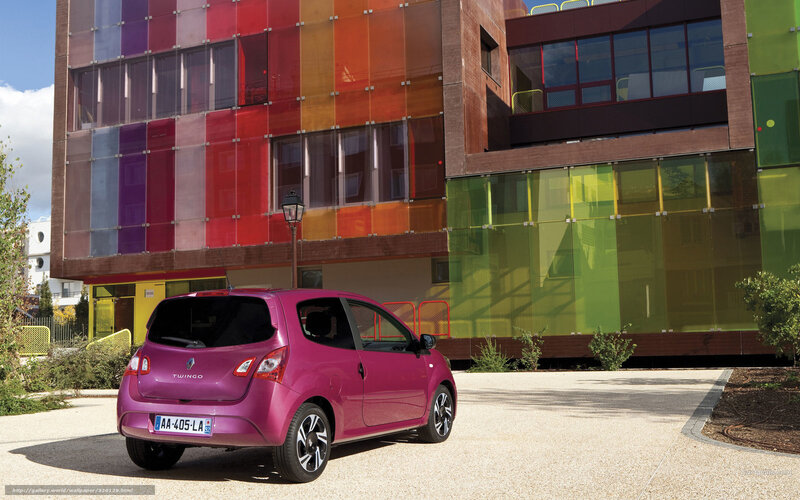 Pink Renault Twingo in front of colorful building