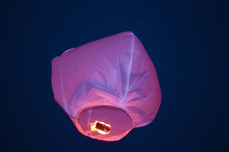 Pink sky lantern at night