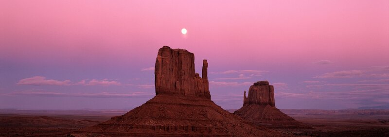 Pink sky over desert rock formations