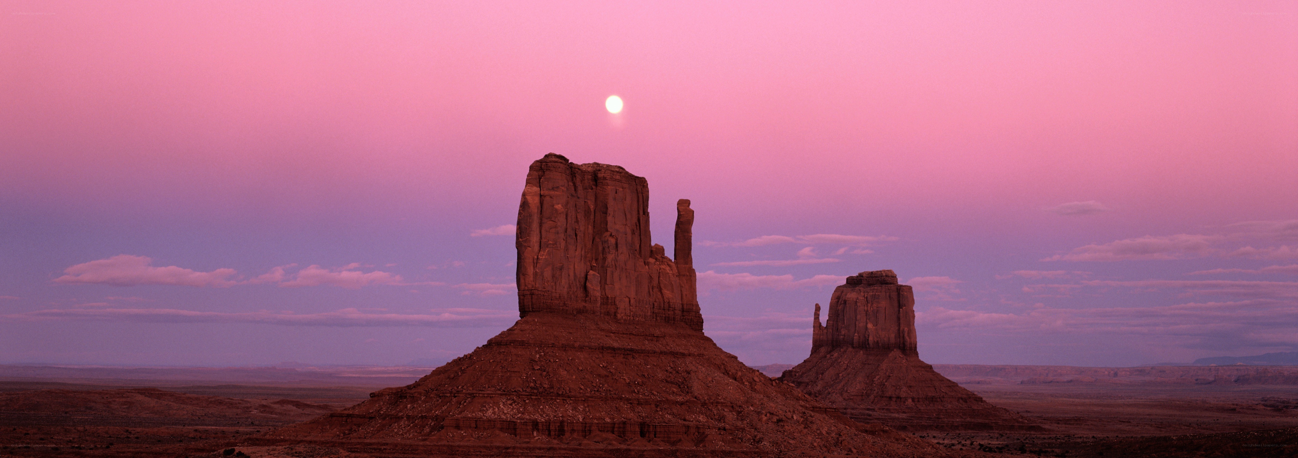 Pink sky over desert rock formations