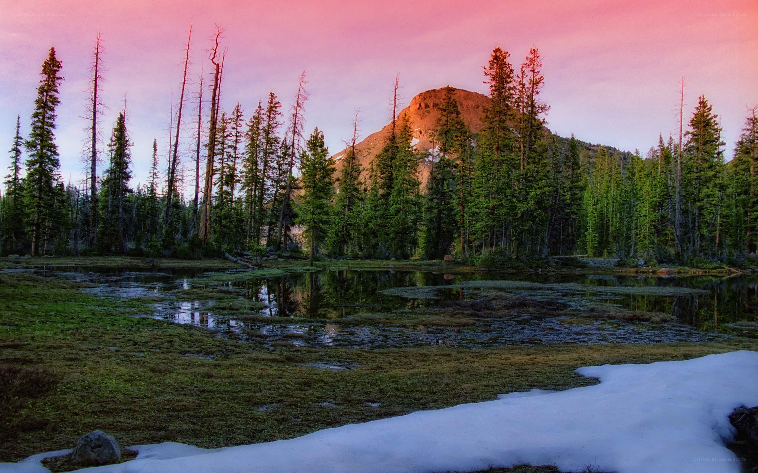 Pink sky over mountain lake