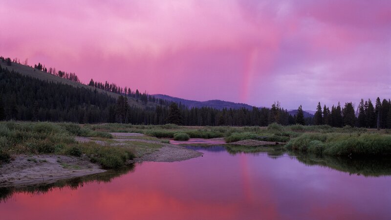 Pink sky over river landscape