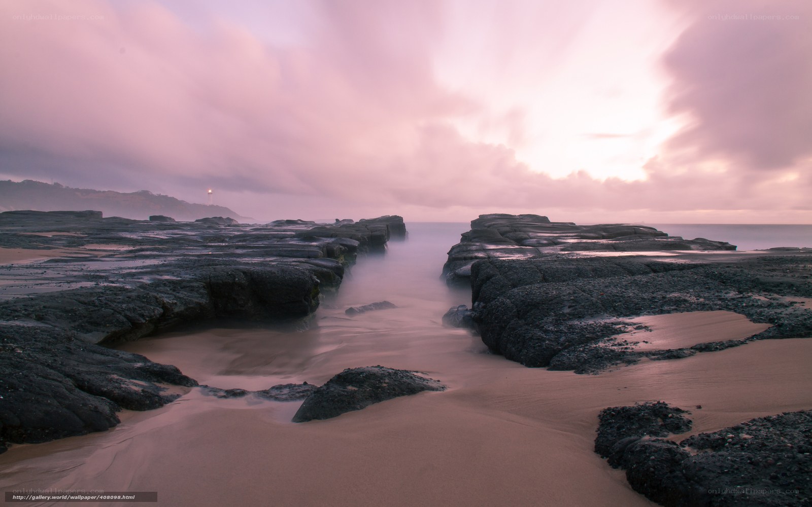 Pink sky over rocky beach