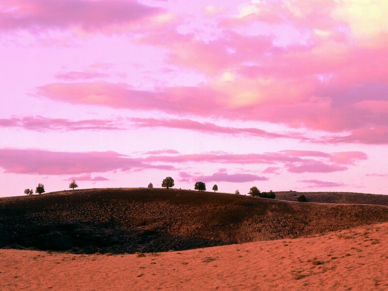 Pink sky over rolling hills