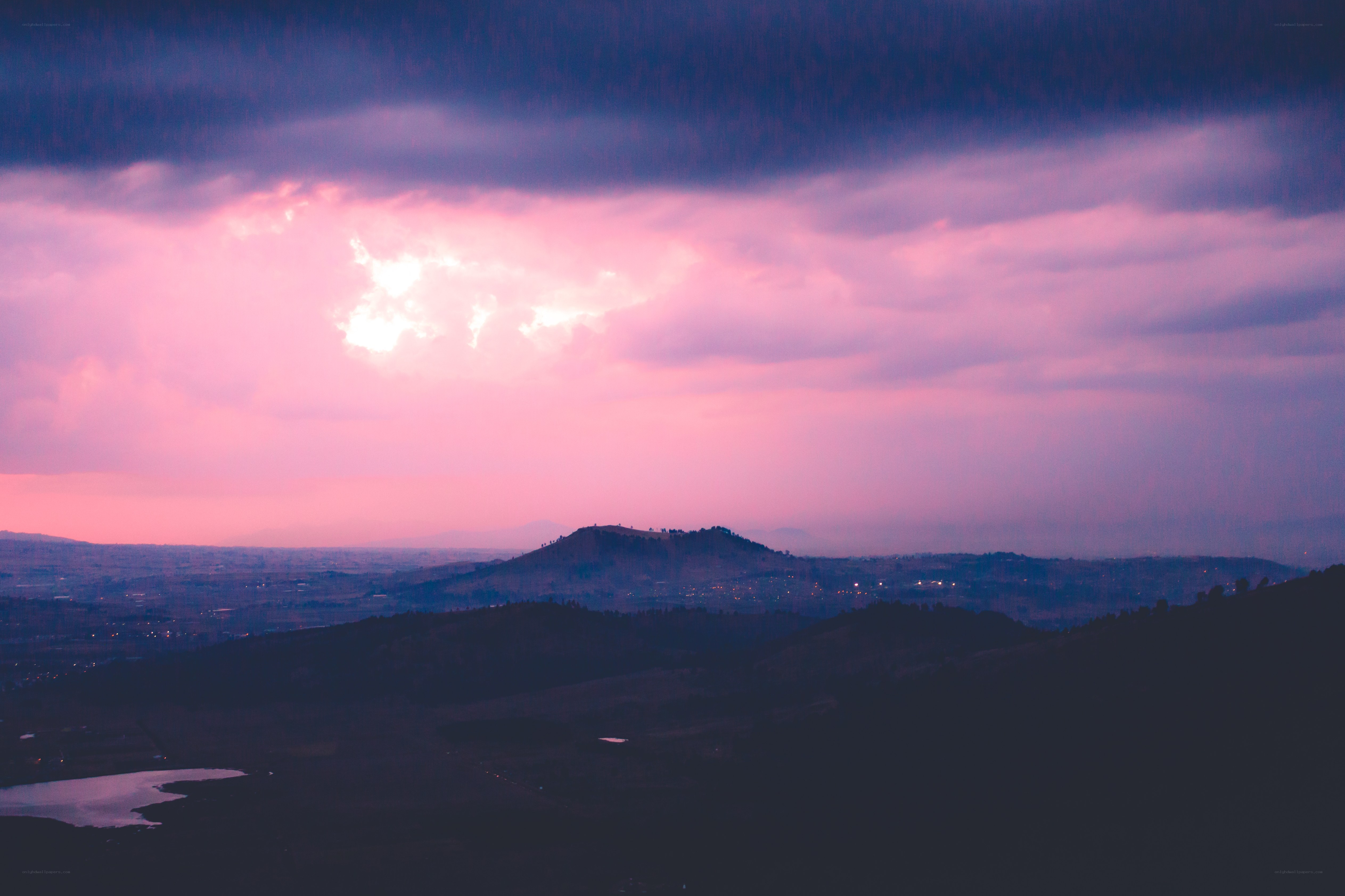 Pink sky over rolling hills