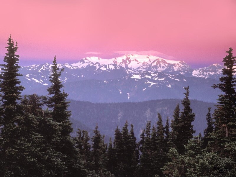 Pink sky over snow-capped mountains