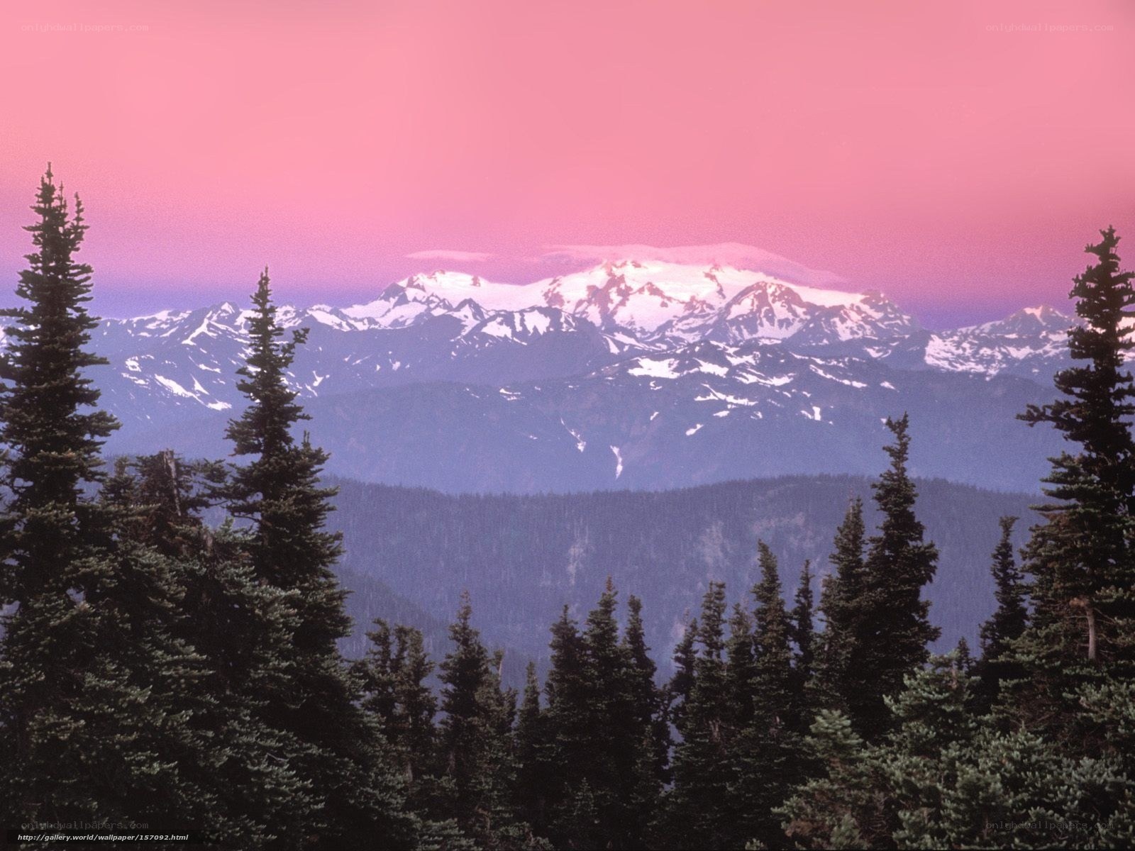 Pink sky over snow-capped mountains