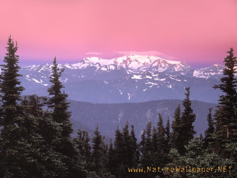 Pink sky over snowy mountains