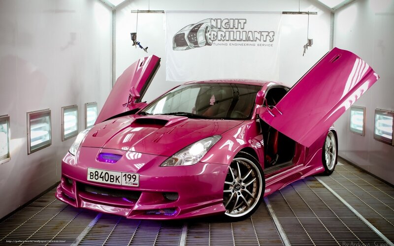 pink sports car in paint booth