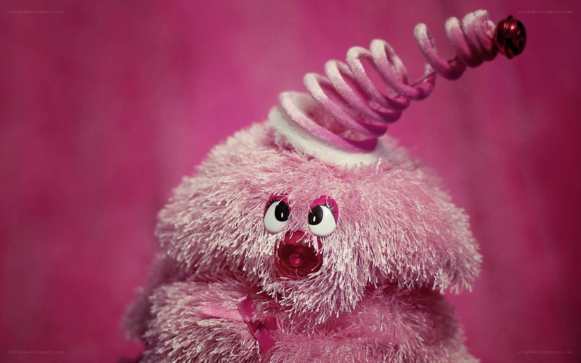 pink stuffed toy with spiral hat